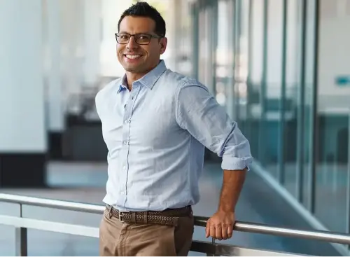 A guy standing with light blue shirt